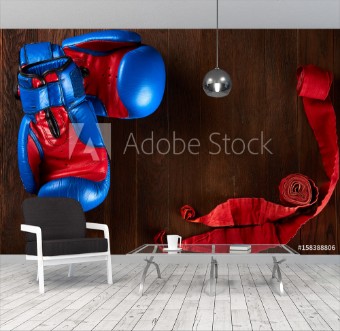 Picture of Sport background with blue and red gloves and red bandage on wooden background